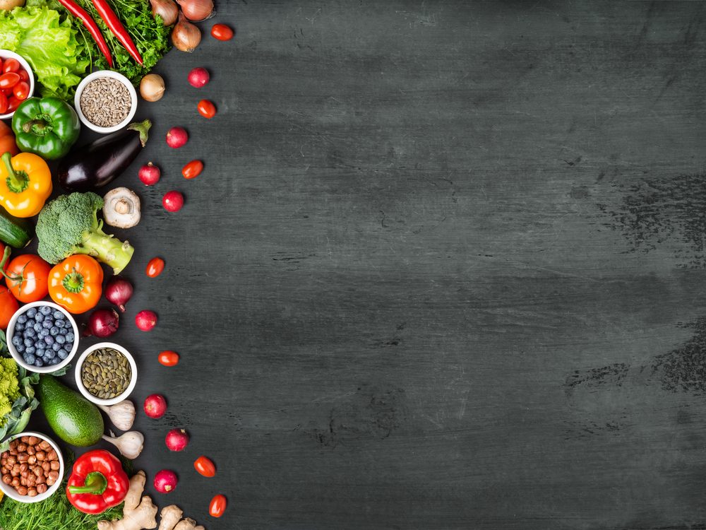 Illustration of a bowl of fresh, colorful whole foods with botanicals and rising vitality